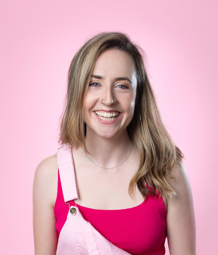 Viv Ford smiling against a pink background